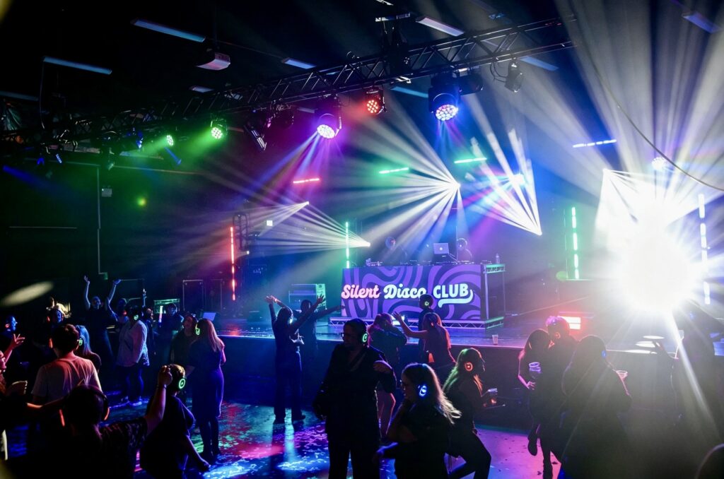 Packed silent disco dancefloor in front of the Silent Disco Club booth