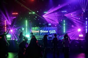 Silent Disco Club booth under purple lasers with the crowd