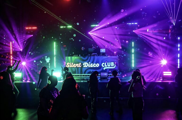 Silent Disco Club booth under purple lasers with the crowd