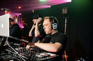 Two DJs at the decks during a silent disco