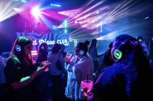 Guests in green-channel headphones at the Silent Disco Club booth